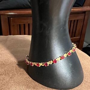 Faux gold hearts with red stones bracelet.